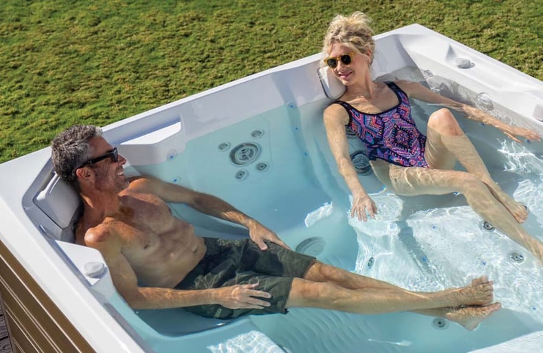 Couple Lounging In Energy Efficient Hot Tub