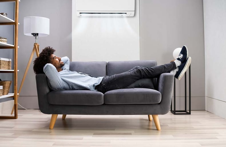 Man Relaxing In Mid Century Modern Loveseat