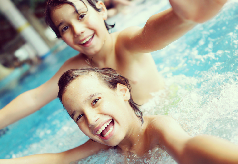 pool chemicals, chlorine - Kids in pool having fun
