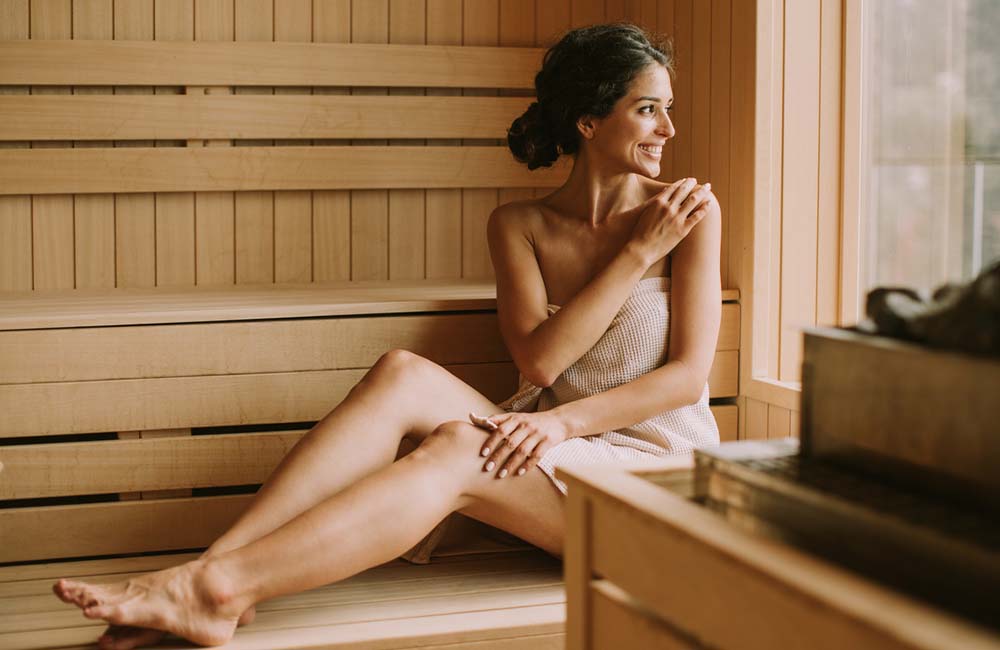 Woman relaxing in sauna